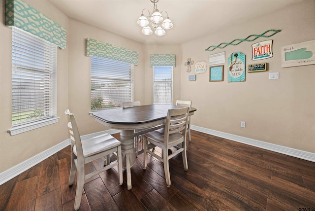 dining area featuring a wealth of natural light, a notable chandelier, and dark hardwood / wood-style floors