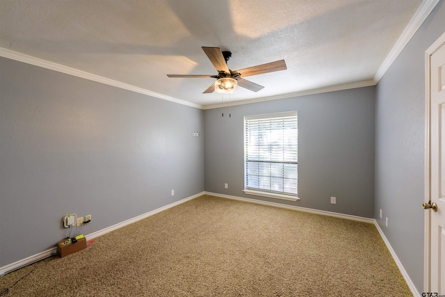 empty room with ceiling fan, crown molding, and carpet