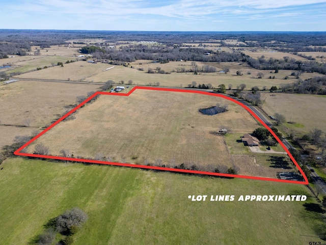 birds eye view of property with a rural view