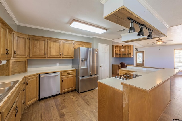 kitchen with stainless steel appliances, a center island, light wood-type flooring, ceiling fan, and ornamental molding