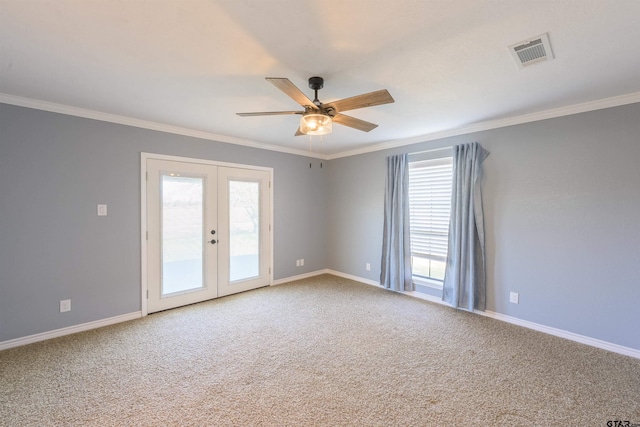 unfurnished room with french doors, ornamental molding, and carpet