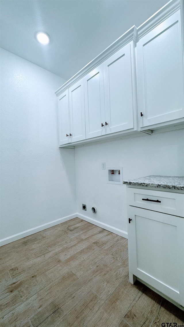 20428 High Point Dr, Flint, TX 75762 - washroom with washer hookup, light wood-type flooring, cabinet space, and electric dryer hookup