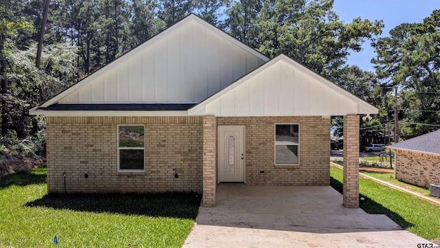 20428 High Point Dr, Flint, TX 75762 - view of front of home with a front lawn, board and batten siding, and brick siding