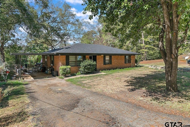 245 Pinecrest St, Rusk, TX 75785 - view of front facade with concrete driveway, brick siding, and a carport