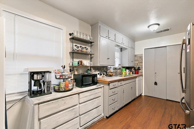 245 Pinecrest St, Rusk, TX 75785 - kitchen with black microwave, a sink, freestanding refrigerator, light countertops, and white dishwasher