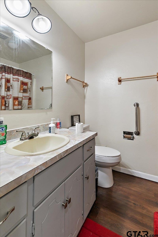 245 Pinecrest St, Rusk, TX 75785 - bathroom with vanity, wood finished floors, toilet, and baseboards