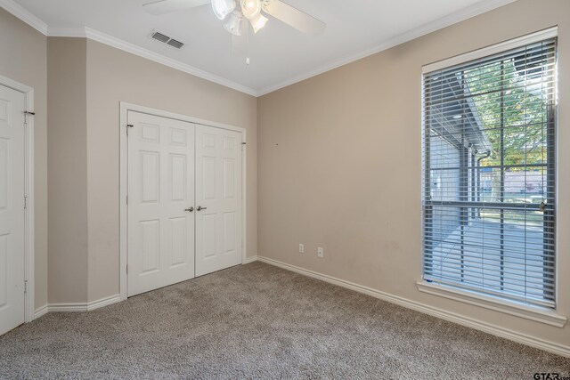 unfurnished bedroom with carpet, ceiling fan, and ornamental molding