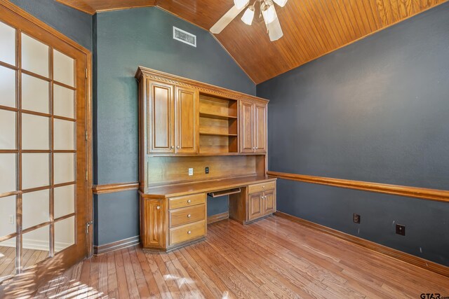 unfurnished office with ceiling fan, built in desk, vaulted ceiling, wood ceiling, and light wood-type flooring