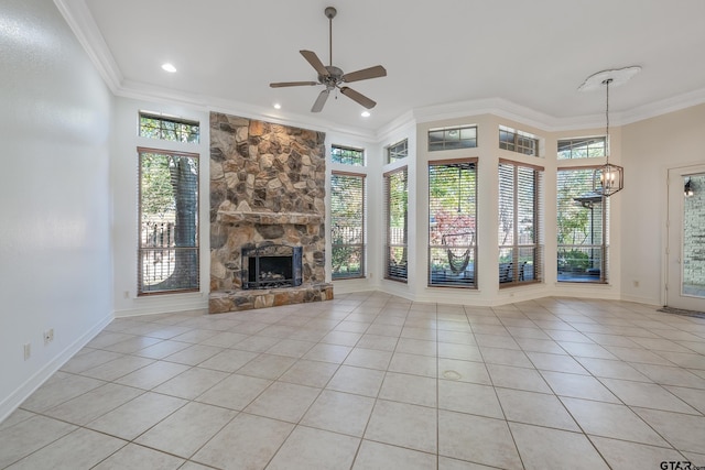 unfurnished living room featuring a stone fireplace, ceiling fan, light tile patterned floors, and ornamental molding