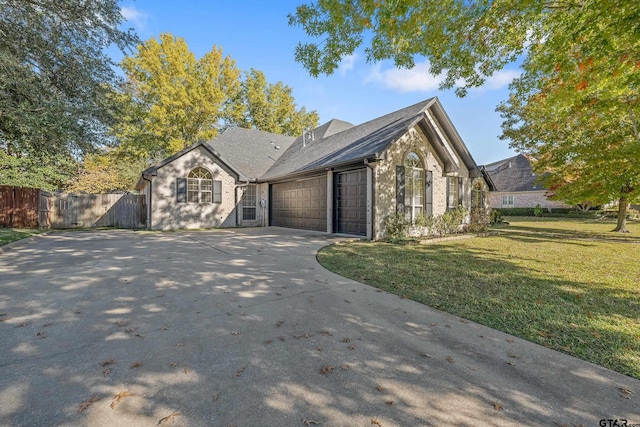 view of front facade featuring a front yard and a garage