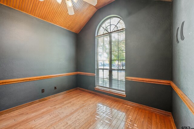 unfurnished room with ceiling fan, hardwood / wood-style floors, wood ceiling, and vaulted ceiling