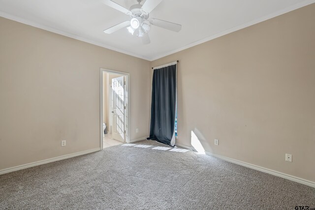 empty room featuring light carpet, crown molding, and ceiling fan