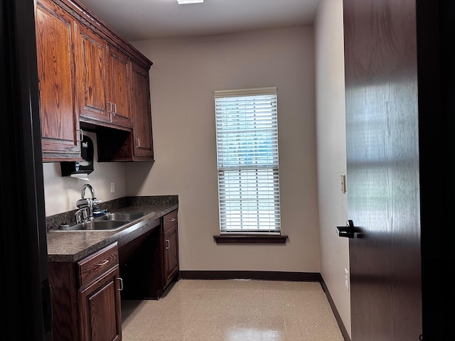 133 E Reagan St, Palestine, TX 75801 - kitchen with a sink, dark countertops, healthy amount of natural light, and baseboards
