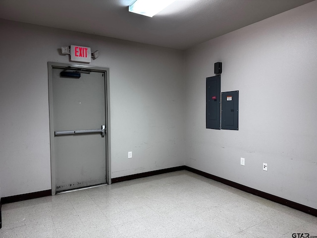 133 E Reagan St, Palestine, TX 75801 - unfurnished room with electric panel, baseboards, and tile patterned floors