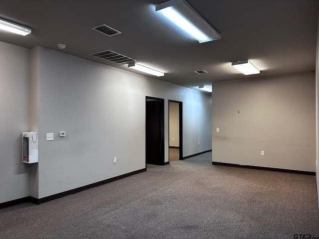 133 E Reagan St, Palestine, TX 75801 - carpeted empty room with baseboards and a smoke detector
