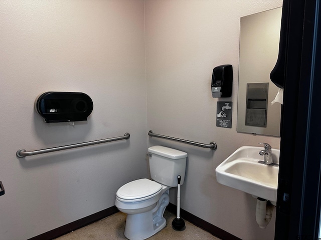 133 E Reagan St, Palestine, TX 75801 - half bathroom featuring toilet, baseboards, and a sink