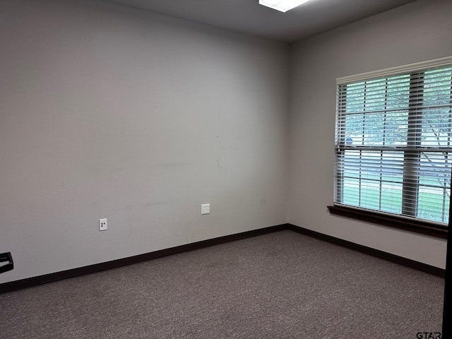 133 E Reagan St, Palestine, TX 75801 - spare room with baseboards and dark carpet