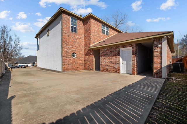 rear view of property featuring cooling unit