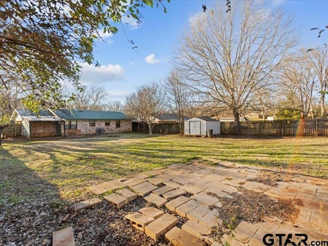 view of yard featuring a storage shed and a patio