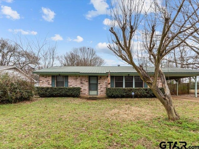 single story home featuring a carport and a front yard