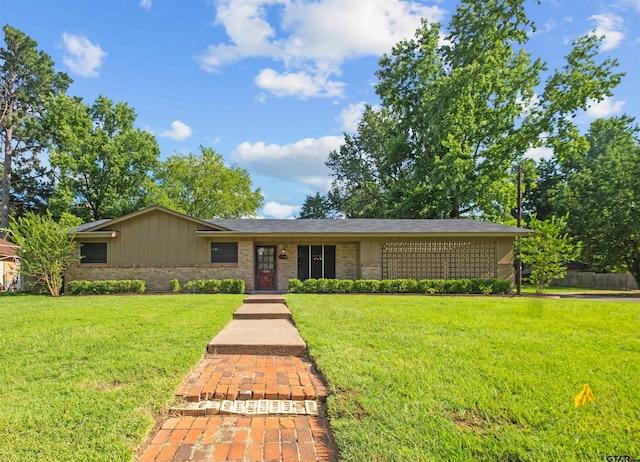 1330POWERS Drive Dr, Tyler, TX 75701 - view of front facade featuring a front yard, brick siding, and board and batten siding