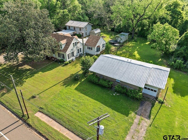 drone / aerial view featuring a wooded view