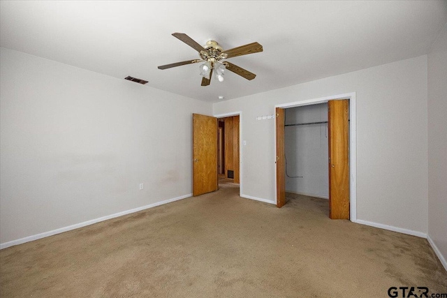 unfurnished bedroom featuring carpet, a closet, a ceiling fan, visible vents, and baseboards