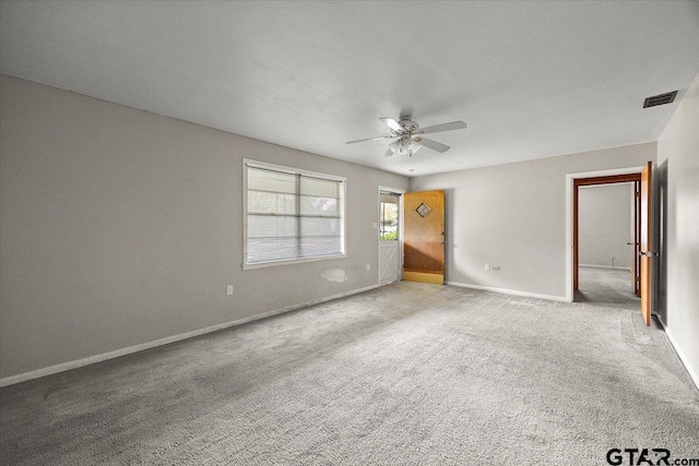 interior space with visible vents, ceiling fan, carpet, and baseboards