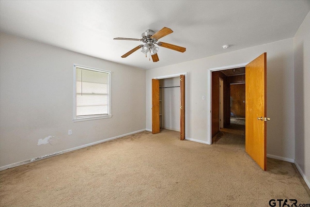 unfurnished bedroom featuring a closet, baseboards, a ceiling fan, and light carpet