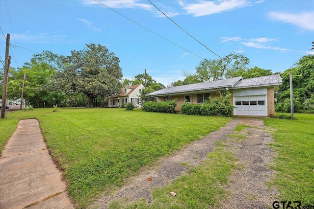 view of front of property with a front yard, driveway, and an attached garage