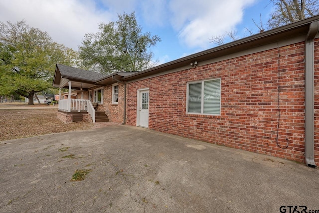 view of side of home featuring a porch