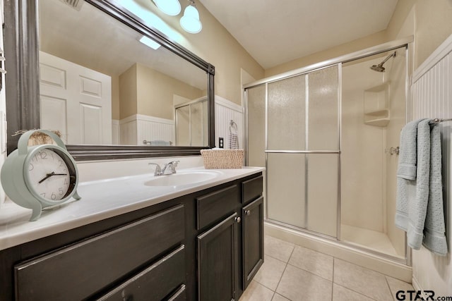 bathroom featuring vanity, tile patterned floors, and a shower with door