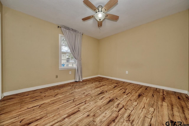 spare room featuring ceiling fan and light hardwood / wood-style floors