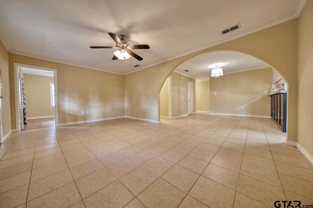 empty room featuring ceiling fan, light tile patterned flooring, and ornamental molding