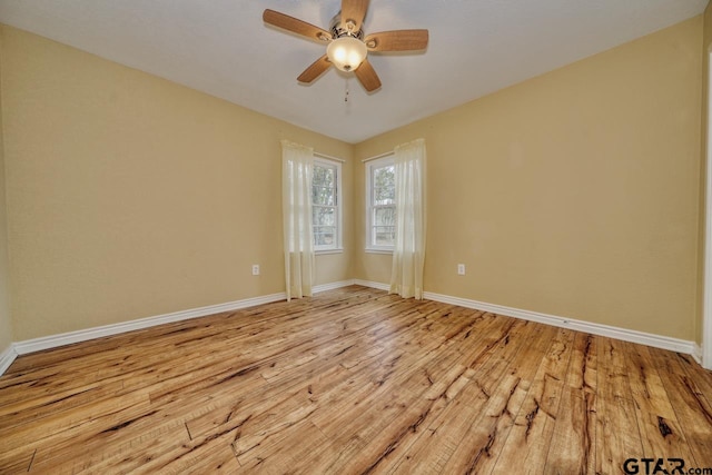 unfurnished room with ceiling fan and light wood-type flooring