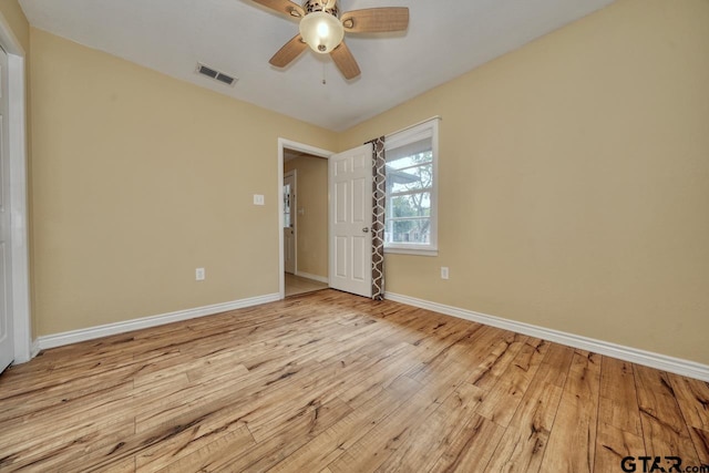 empty room featuring ceiling fan and light hardwood / wood-style floors