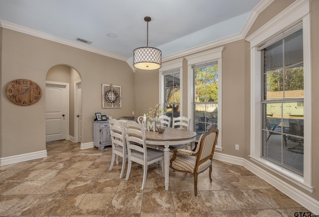 dining room featuring crown molding