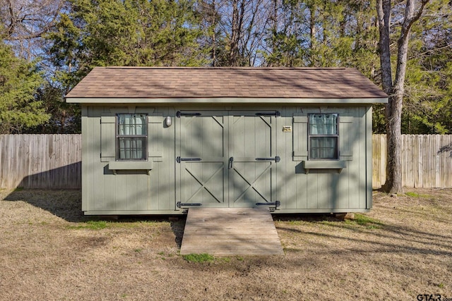 view of outbuilding with a yard