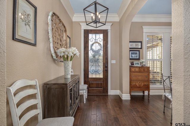 entryway featuring ornamental molding, dark hardwood / wood-style floors, and a chandelier