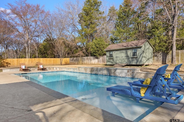 view of pool featuring an outdoor fire pit, an outdoor structure, and a patio