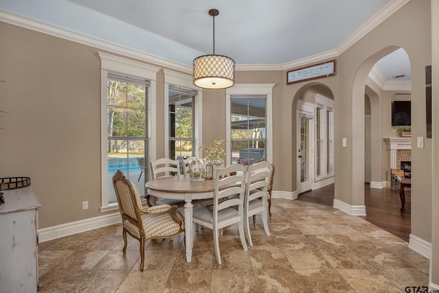 dining space featuring crown molding