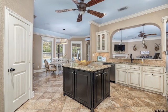 kitchen featuring pendant lighting, dishwasher, sink, decorative backsplash, and light stone counters