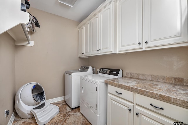 laundry room with washer and clothes dryer and cabinets