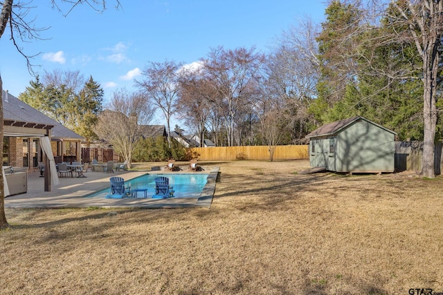 view of pool featuring a patio, a yard, and a storage unit