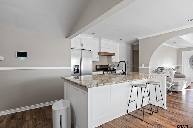 kitchen with white cabinetry, sink, stainless steel appliances, light stone counters, and dark hardwood / wood-style floors