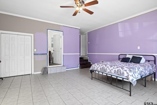 tiled bedroom featuring ceiling fan, ornamental molding, and a closet