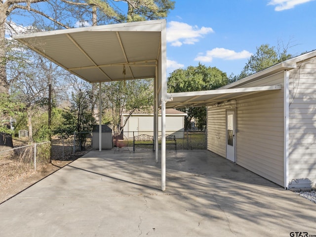 view of patio featuring a carport and an outbuilding