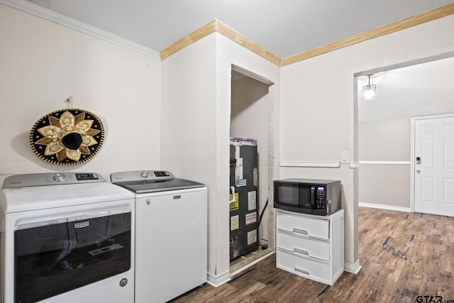 laundry area featuring dark hardwood / wood-style floors, separate washer and dryer, and ornamental molding