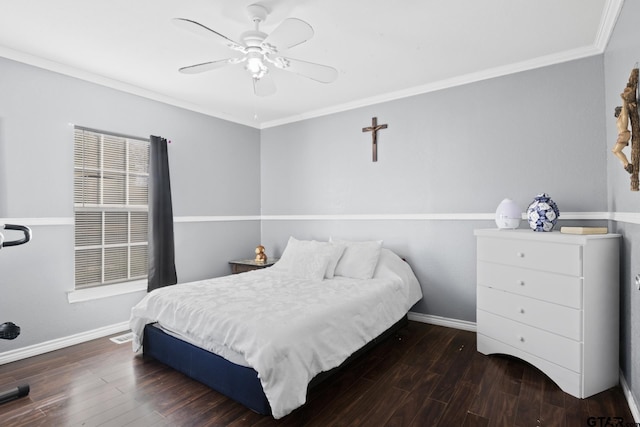 bedroom with ceiling fan, ornamental molding, and dark wood-type flooring