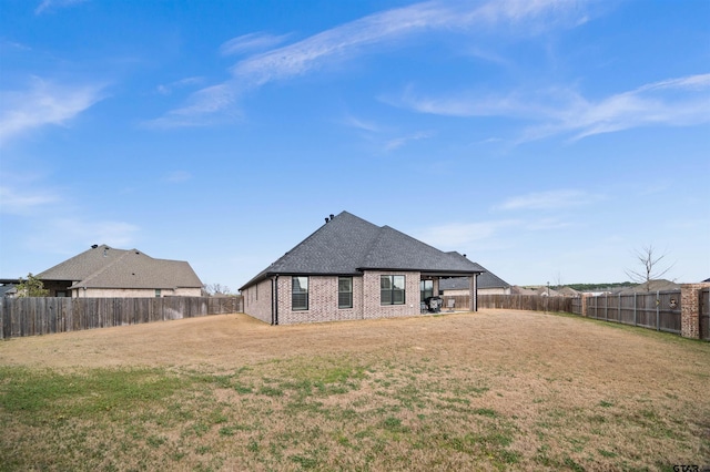 back of house with a lawn